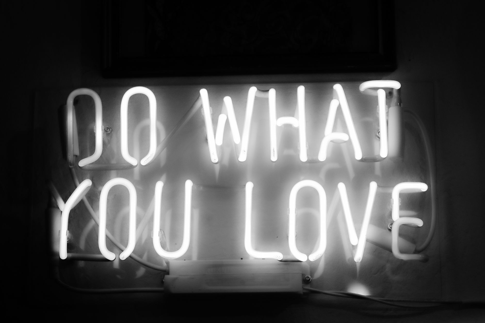 Monochrome neon sign with inspiring message 'Do What You Love' in Riga, Latvia.